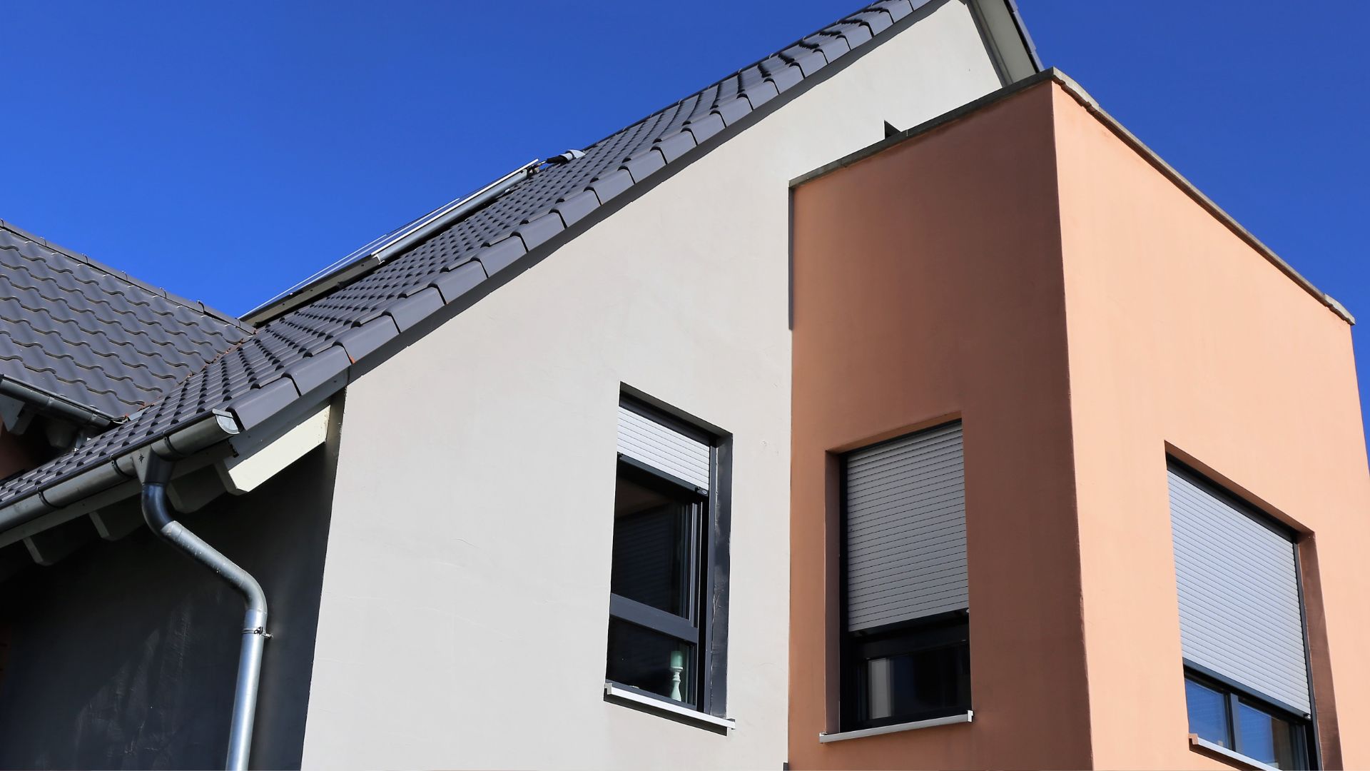 A house with a metal gutter on the roof