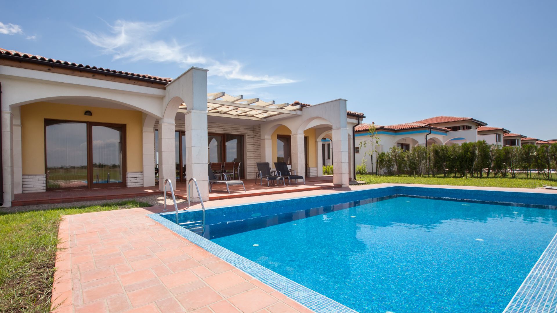 A house with a swimming pool in front of it