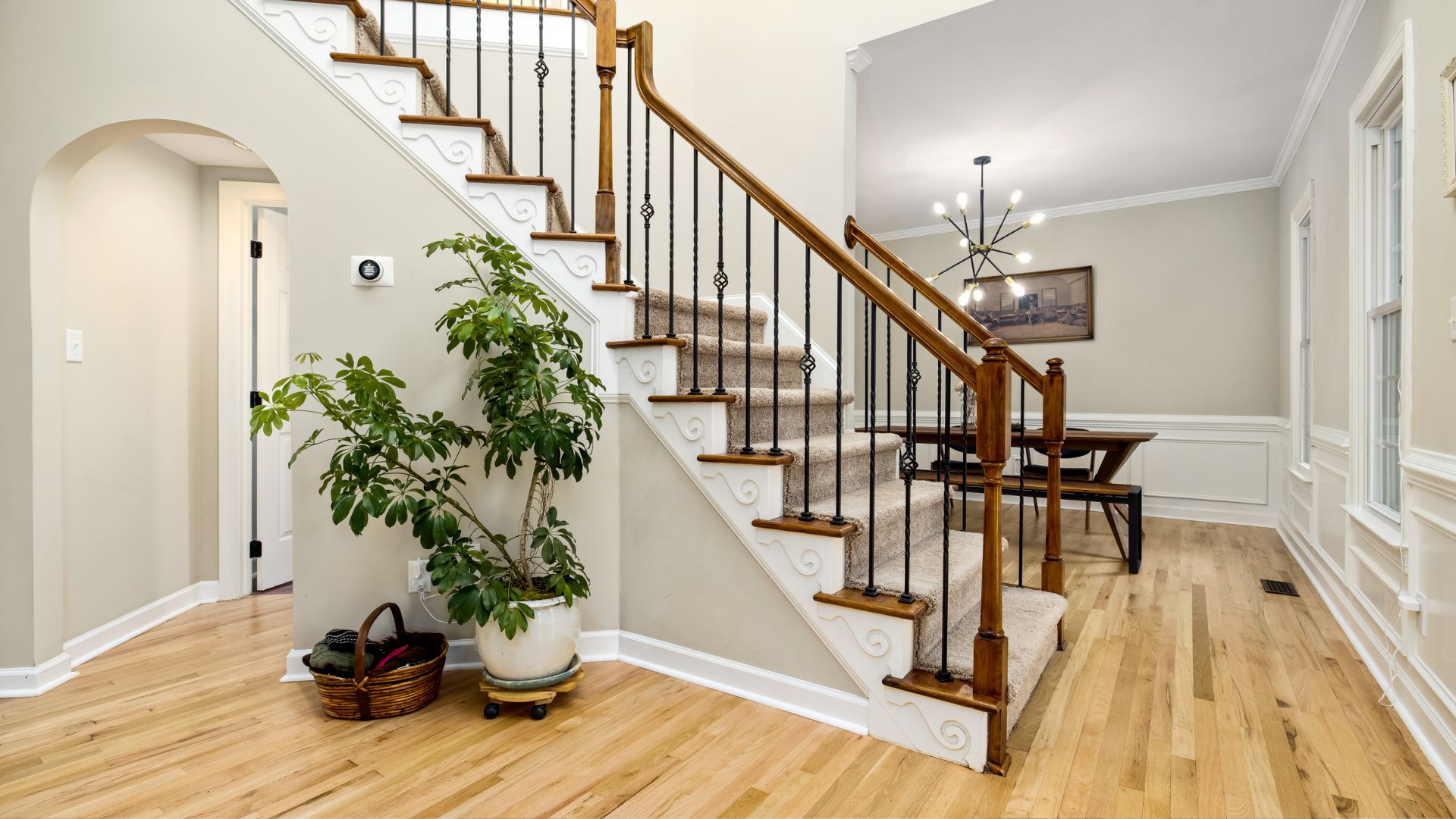 A staircase in a house with a potted plant next to it