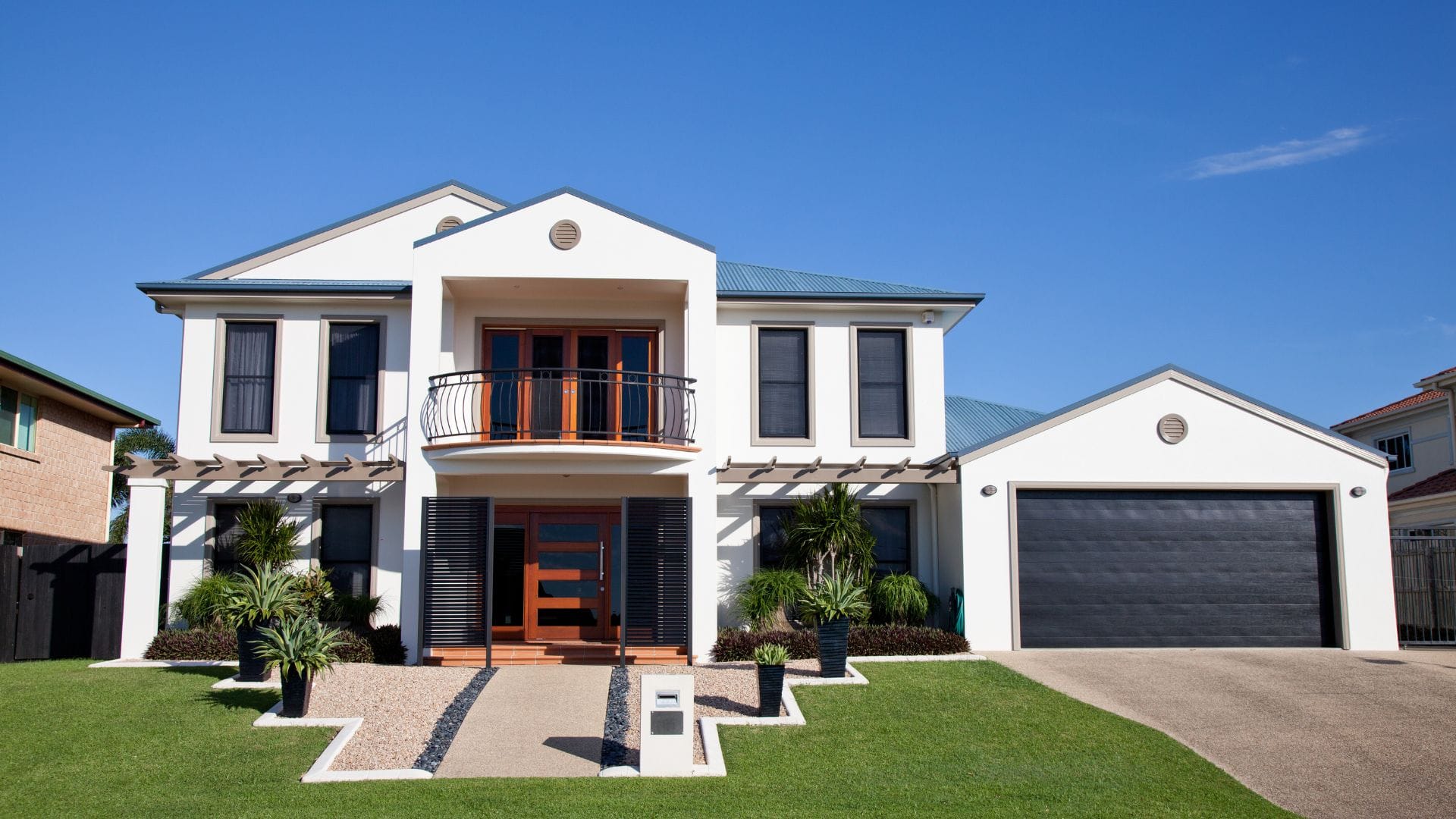 Freshly painted white commercial-style building under a blue Montana sky