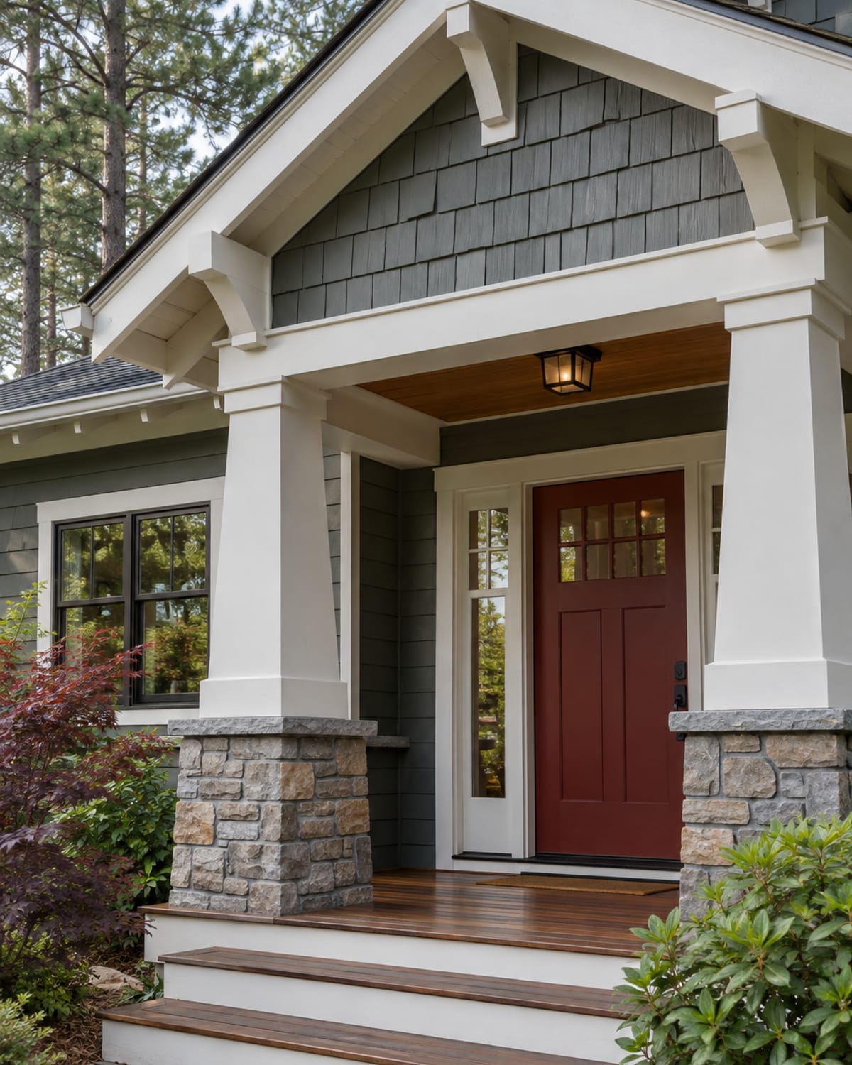 Freshly painted craftsman porch columns, shingle gable and deep red front door on a Helena, MT home