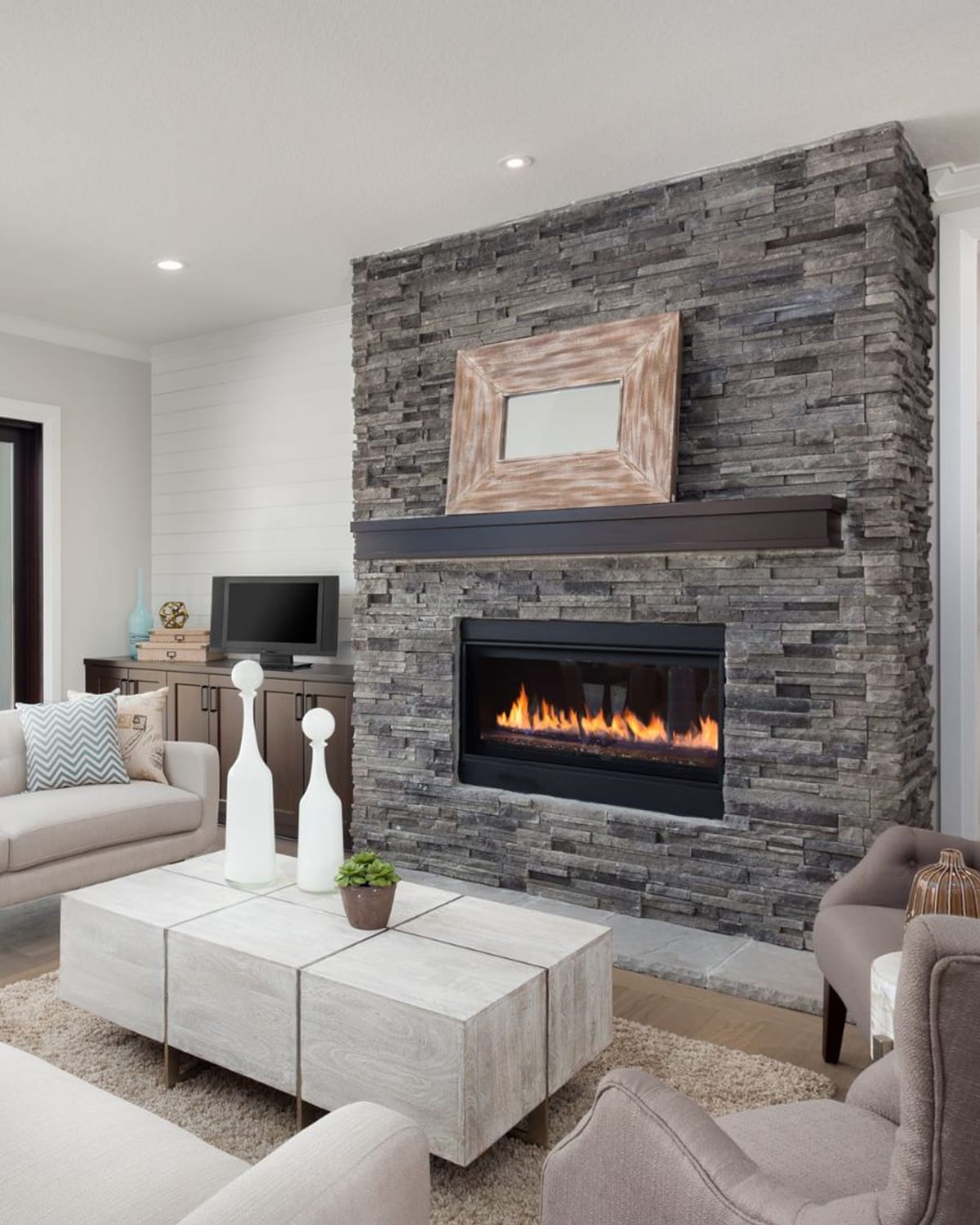 Finished living room with fresh neutral walls and a stone fireplace after an interior repaint in Great Falls