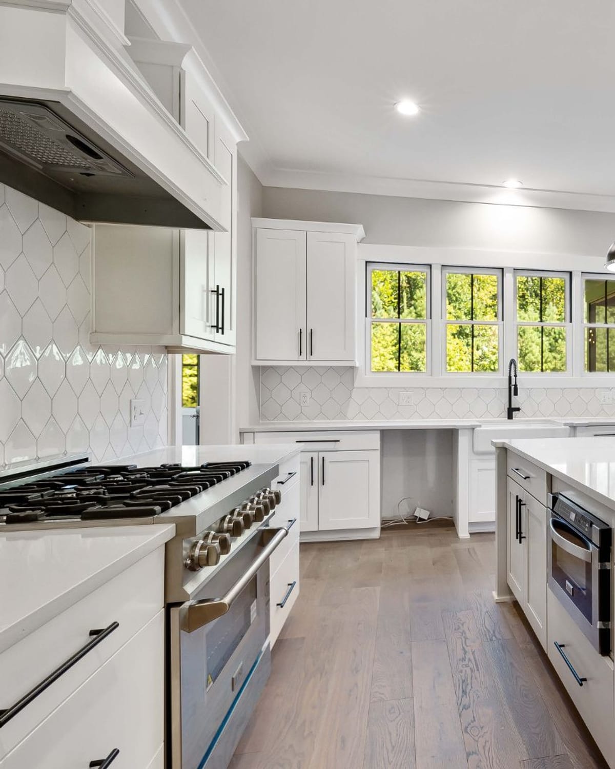 Bright white kitchen with freshly painted cabinet trim, crown molding and window casings